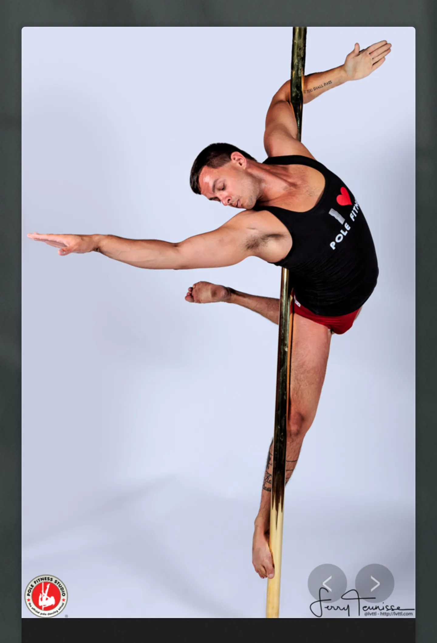 Cody holding a strength pose on the pole
